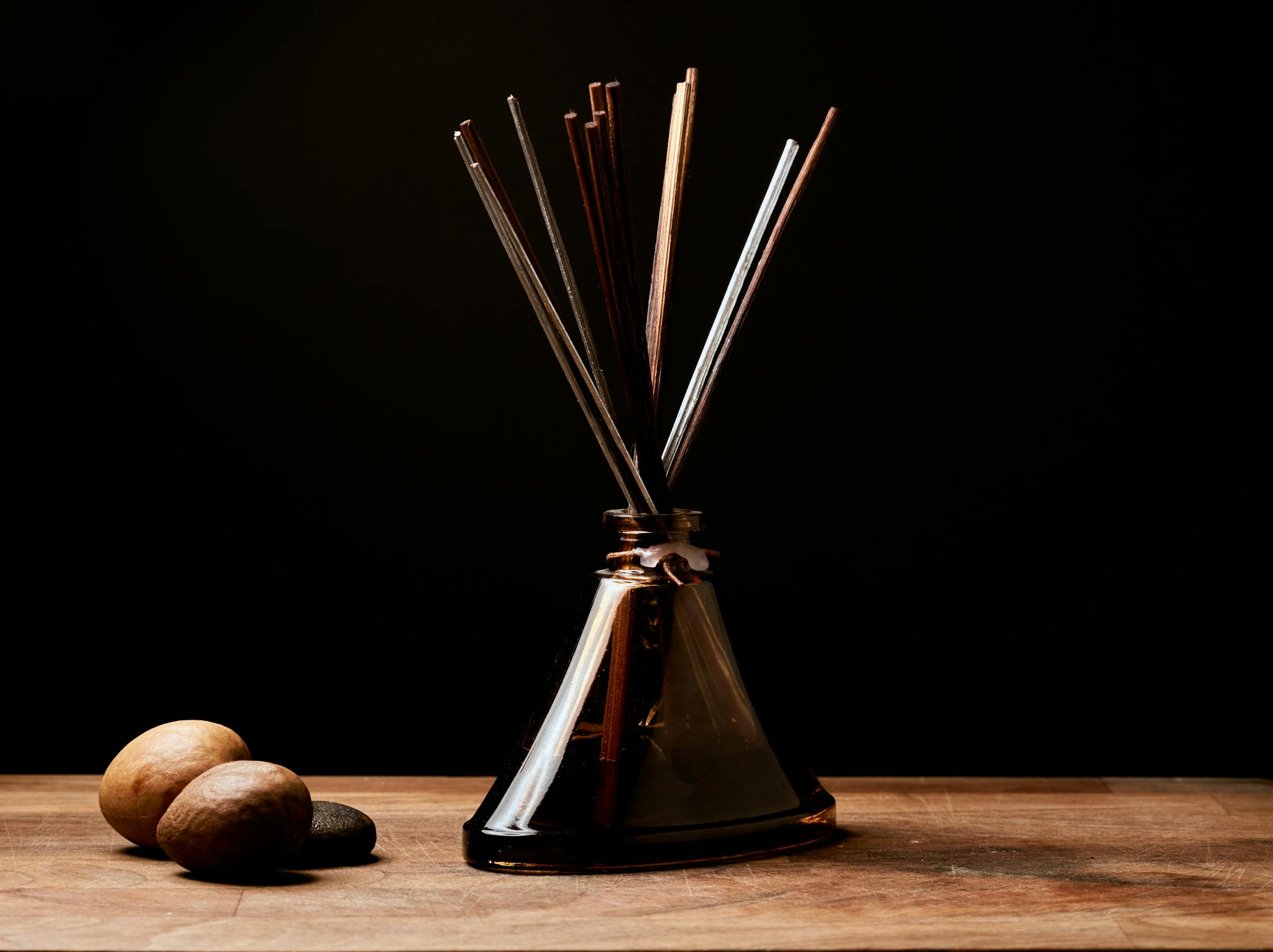 Warm and rustic aroma setting with incense sticks in a bottle, perfect for relaxation.